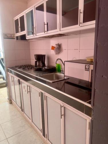 a kitchen with a sink and a counter top at Tres habitaciones con Cuatro Aires acondicionados y Super lindo in Florencia