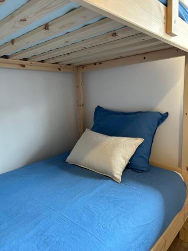a bunk bed with a blue bedsheet and a pillow at Casa Moledo in Moledo
