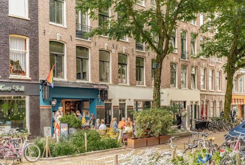 a group of people sitting outside of a building at LIEV Amsterdam Cozy boutique suite in The Pijp in Amsterdam