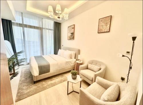 a bedroom with a bed and a couch and a chair at Dubai Galaxy in Azizi Riviera Luxury Studio in Dubai