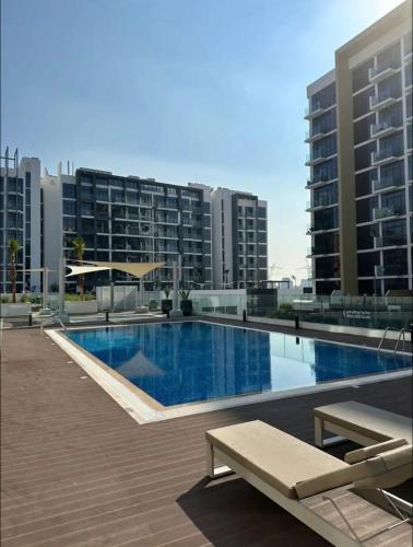 a large swimming pool on top of a building at Dubai Galaxy in Azizi Riviera Luxury Studio in Dubai