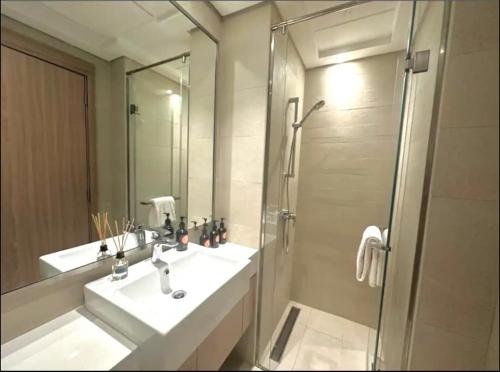 a bathroom with a sink and a shower at Dubai Galaxy in Azizi Riviera Luxury Studio in Dubai
