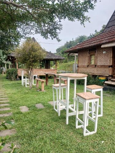 a group of tables and stools in a yard at Kebun Teduh Sukaharja Cijeruk Bogor in Palasari