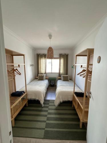 a bedroom with two beds and a window at Casa Moledo in Moledo