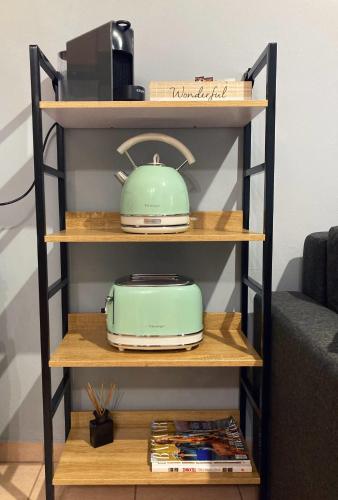 a shelf with a teapot and a toaster on it at M.O.M.’s in Alexandroupoli