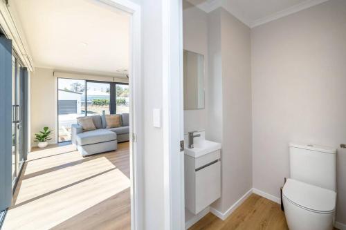 a bathroom with a sink and a toilet in a room at Stonehenge Retreat in Martinborough