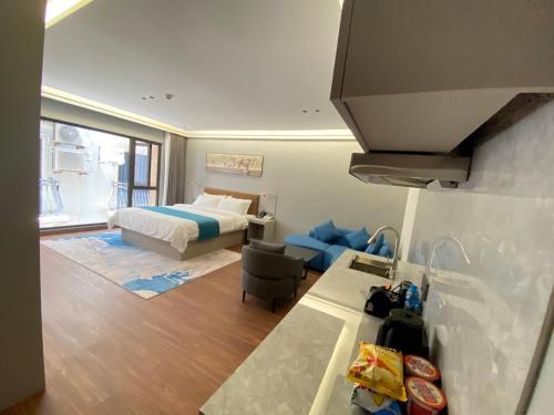 a hotel room with a bed and a kitchen at Sally Hotel in Yen