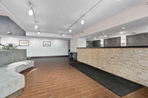a lobby with a brick wall and a bar at Quality Inn & Suites Mall of America - MSP Airport in Bloomington