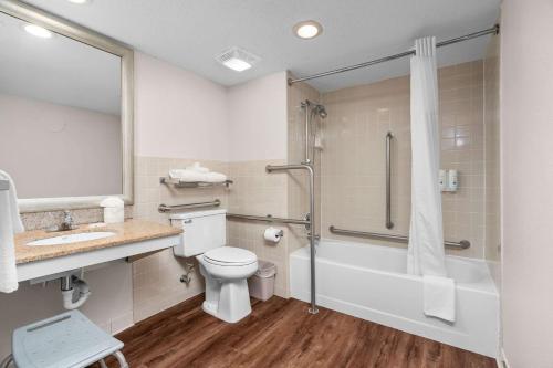 a bathroom with a toilet and a sink and a shower at Quality Inn & Suites Mall of America - MSP Airport in Bloomington