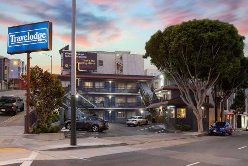 a sign for a hotel on a city street at Travelodge by Wyndham by Fisherman's Wharf in San Francisco