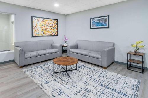 a living room with two couches and a coffee table at Baymont by Wyndham Carlsbad NM in Carlsbad
