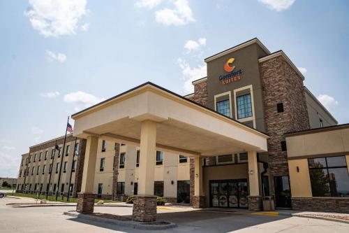 a front view of a hotel with an american flag at Comfort Suites University Brookings in Brookings