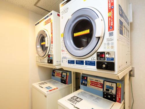 a washer and dryer on display in a room at Comfort Inn Zentsuji Inter in Marugame