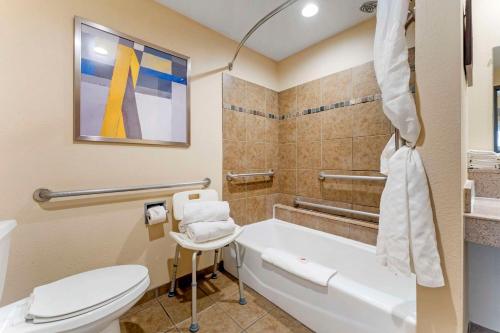 a bathroom with a tub and a toilet and a sink at Comfort Suites Monaca in Monaca