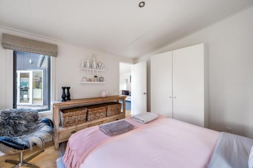 a bedroom with a large bed and a chair at Spectacular views uninterrupted! 3 BR, Private! in Queenstown