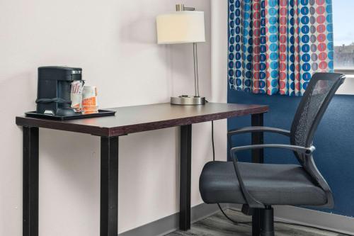a desk with a coffee maker and a chair at Quality Inn & Suites Mall of America - MSP Airport in Bloomington