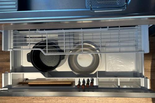 a refrigerator with some pots and pans in it at ZABOCON YOICHI Villa in Yoichi