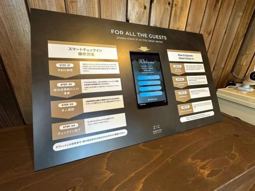 a display sign for an event with a cell phone at ZABOCON YOICHI Villa in Yoichi