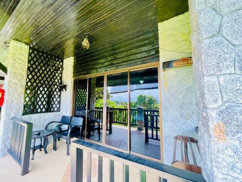 a patio with chairs and tables on a balcony at Boomerang Village Resort Kata in Kata Beach