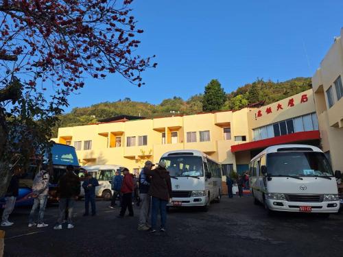a group of people standing in front of a building at Shi Bi Hotel in Gukeng