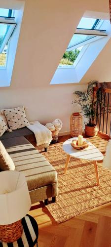 a living room with a couch and a table at Stodoła Rzym - domek, jacuzzi, sauna, jezioro, las in Kożyczkowo