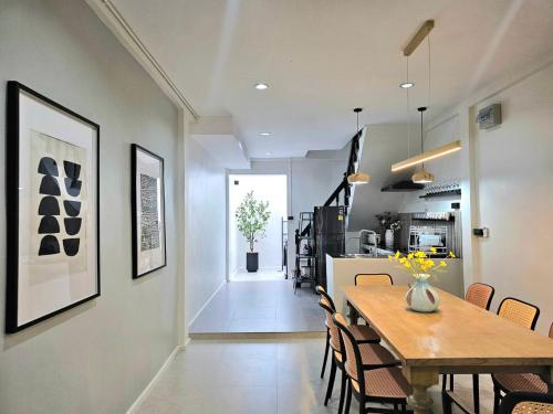a dining room and kitchen with a table and chairs at The Mellow at Thong Lo in Bangkok