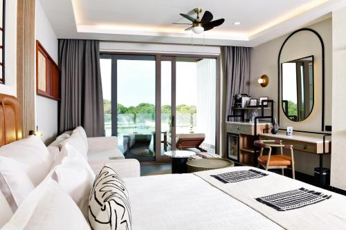 a hotel room with two beds and a desk at Ethno Belek in Belek