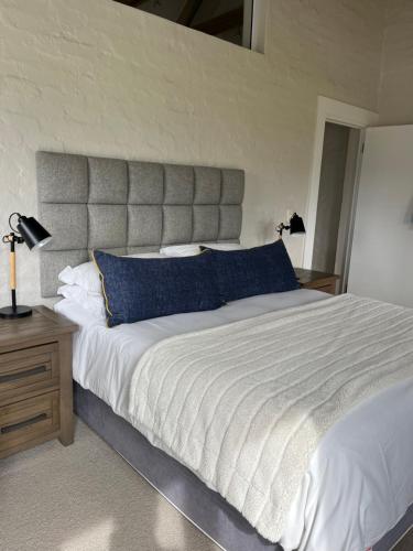 a bedroom with a large bed with blue pillows at Above Par Kingswood in George