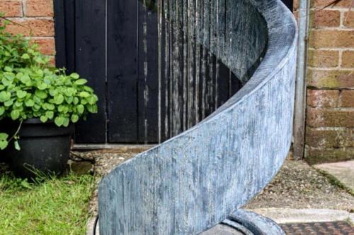 a blue bench sitting in front of a door at HotTub-Nature-FamilyFriendly-WiFi-Parking in Ballykelly