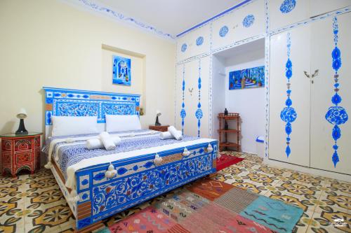 a bedroom with a bed with blue and white at Casa Voyager 'secret garden terrace' in Chefchaouen