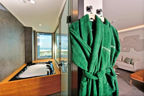 a bathroom with a tub and a green towel at Ethno Belek in Belek