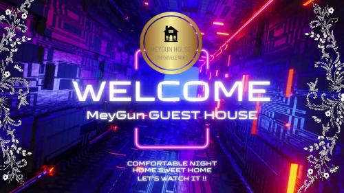 a neon welcome sign for a west end guest house at MeyGun House in Lovina