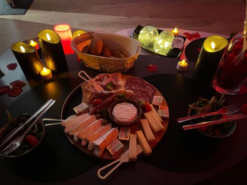 a table with a plate of food on a table at La Clé des Champs - Studio PiscineSPA-Sauna au jardin tropical idyllique et bucolique in Jouarre