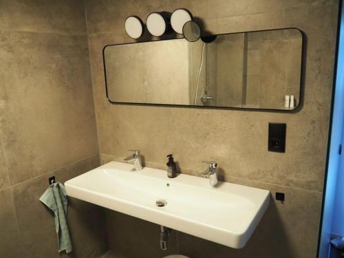 a bathroom with a white sink and a mirror at Häuschen im Ortskern in Perg