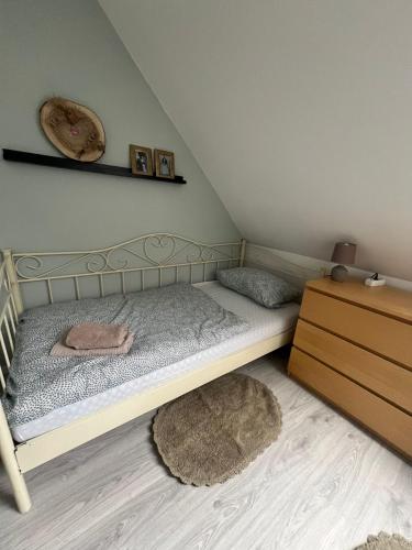 a small bedroom with a bed and a dresser at 3 Zimmer Monteurewohnung in Kirchhain in Kirchhain