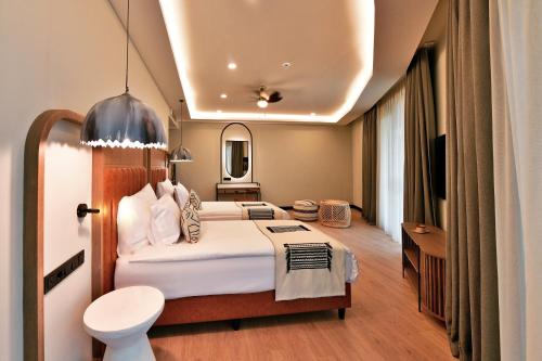 a hotel room with a bed and a bathroom at Ethno Belek in Belek