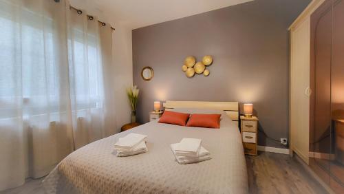 une chambre avec un lit avec deux oreillers dessus dans l'établissement Gîte Unique Le Caijonet proche de Disneyland, Aeroport CDG, Paris, à Villeparisis