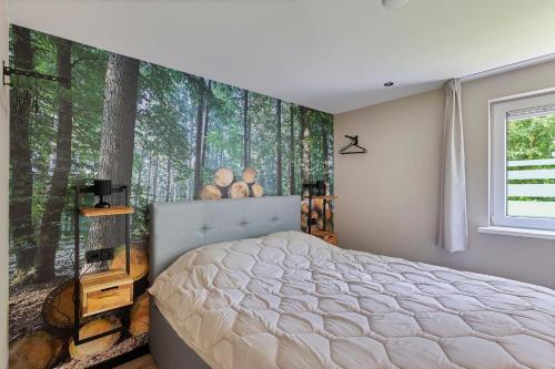 a bedroom with a bed and a window with trees at Comfortabel 2- persoons vakantiehuis nabij bos in Drenthe in Schoonoord