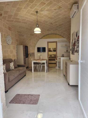 a living room with a couch and a table at Rossè B&B Holiday House in Trani