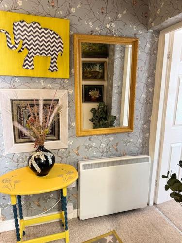 a room with a table and a mirror and a stool at 4 The Haw thornes Sleeps4 NEC 7mins BHX 8mins in Coleshill