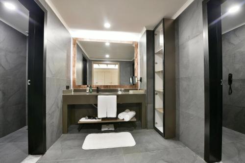 a bathroom with a sink and a mirror at Ethno Belek in Belek