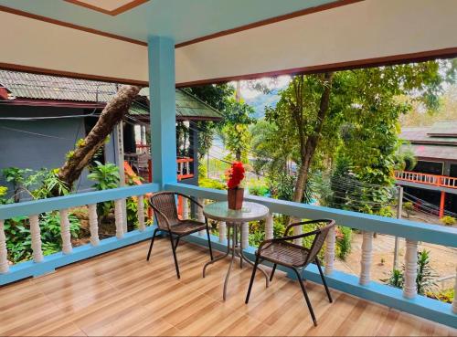 a balcony with a table and chairs on it at Mom Boutique Railay in Railay Beach