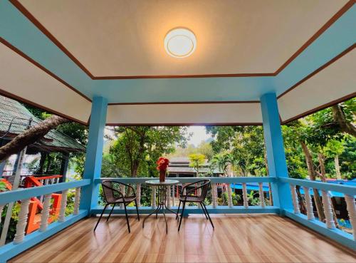 a balcony with a table and two chairs at Mom Boutique Railay in Railay Beach