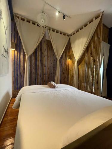 a bedroom with a white bed with a canopy at Eco Lagoon in Phu Quoc