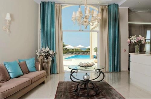 a living room with a couch and a table at Villa Afrodite in Mirina
