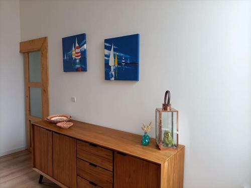 a wooden cabinet with a fish tank on a wall at Maison de vacances près de la digue et plage in Dunkerque