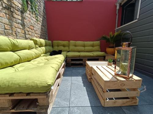 a living room with a couch and a cat sitting on it at Maison de vacances près de la digue et plage in Dunkerque