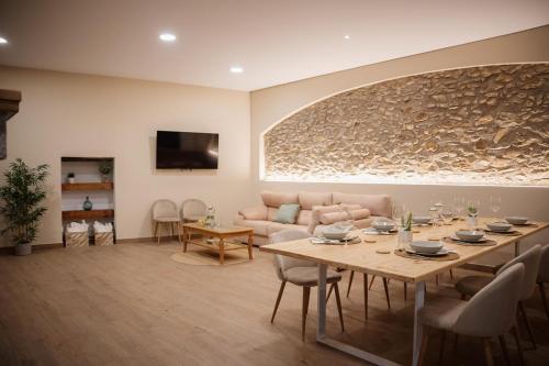 a living room with a table and a couch at El gallinero de la abuela Claudia in Aldea de Trujillo