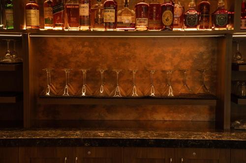 a row of wine glasses sitting on a bar at Home2 Suites by Hilton Fort Walton Beach Eglin AirForce Base in Fort Walton Beach