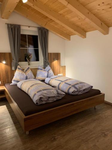 a bedroom with a large bed with pillows on it at Ferienhaus Philipp Rofner in Leogang